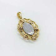 Back view of tri-color gold oval 'MOM' pendant showing flat white-gold center.