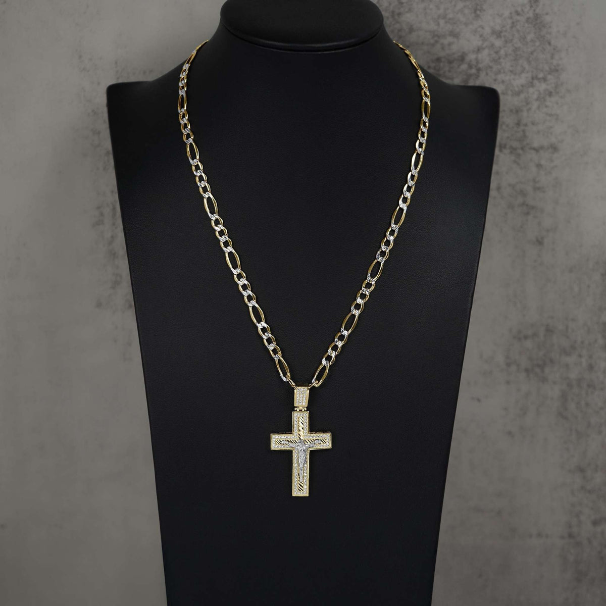 Gold Nemo iced-out crucifix pendant necklace displayed on a black mannequin bust.