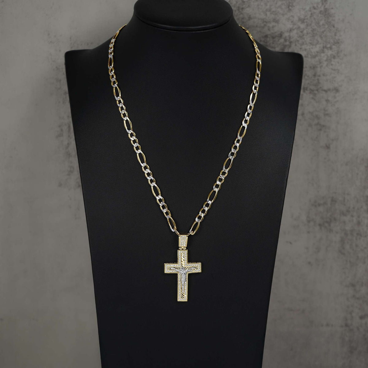 Gold crucifix cross pendant with pavé cubic zirconia, displayed on a black mannequin bust.