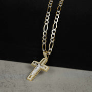 Yellow and white gold crucifix pendant with sparkling cubic zirconia, hanging from a Figaro chain.