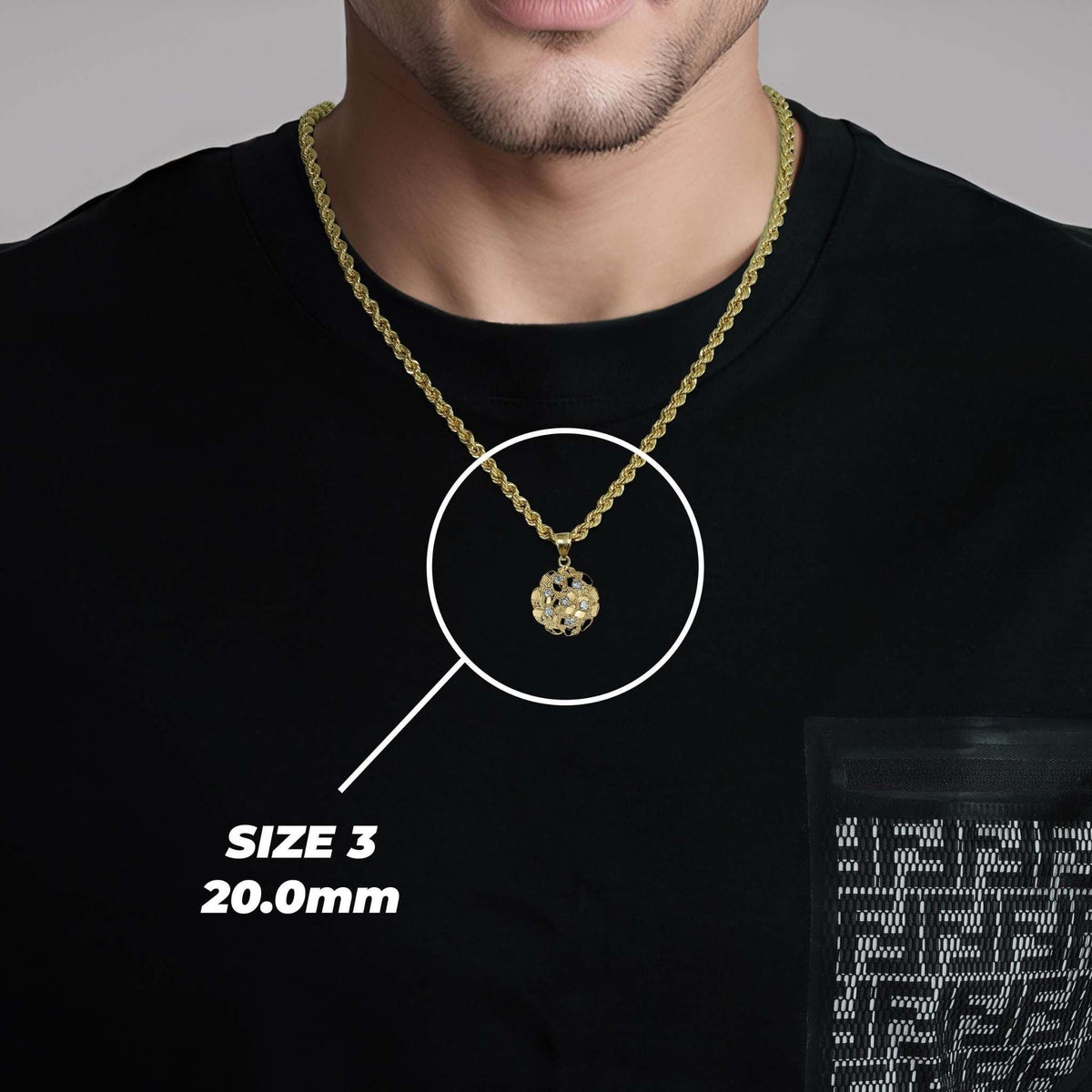 Size 3 gold nugget CZ pendant on rope chain worn on person.