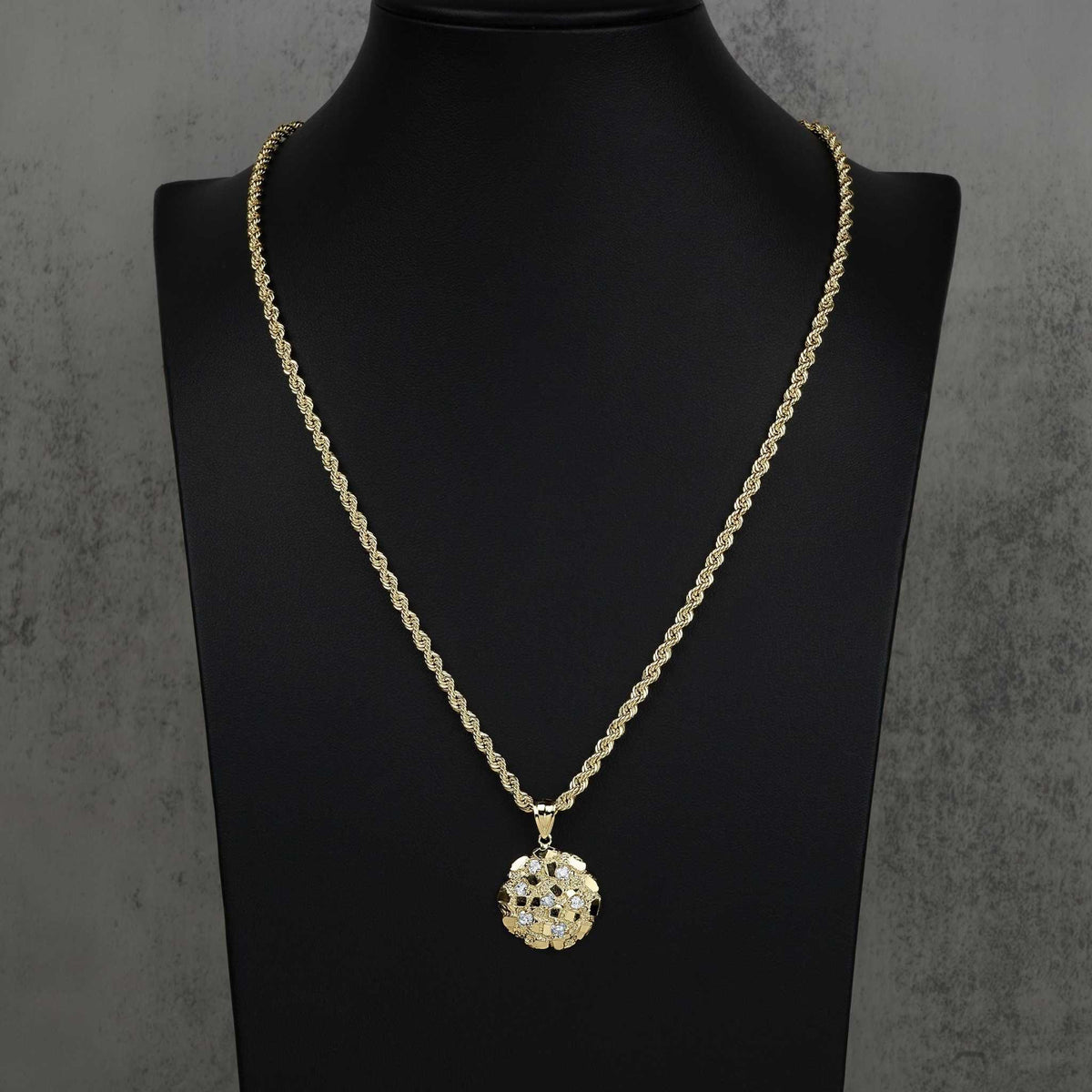 Gold nugget round CZ pendant on rope chain displayed on a black mannequin bust.