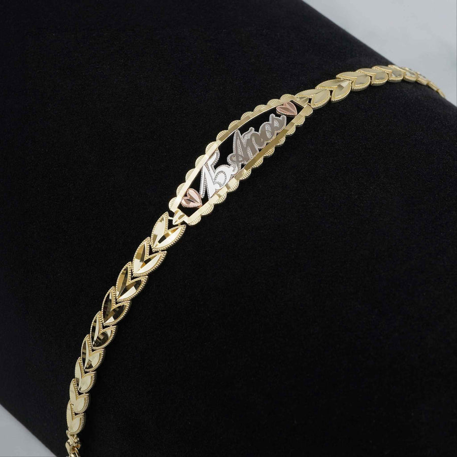 Tri-color gold Quinceañera "15 Años" leaf link bracelet displayed on dark background.