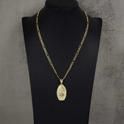 Gold Our Lady of Guadalupe oval pendant necklace on a figaro chain displayed on a black neck bust.