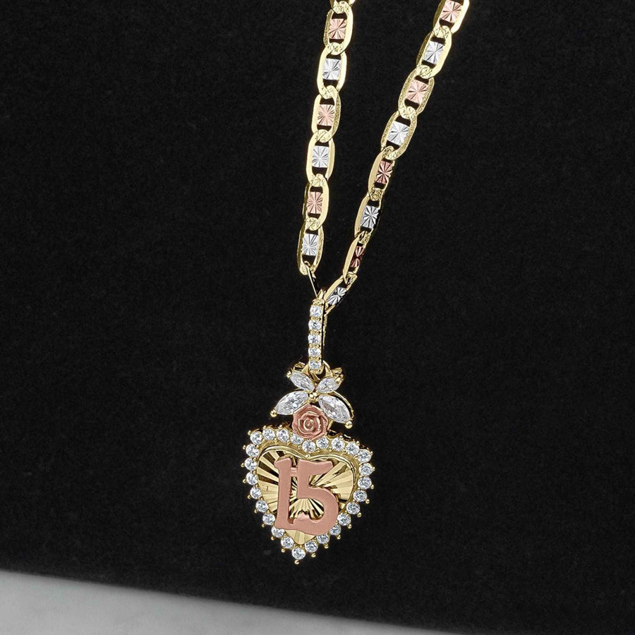 Gold Quinceañera heart pendant with 15 design, CZ accents, and rose gold floral detail.