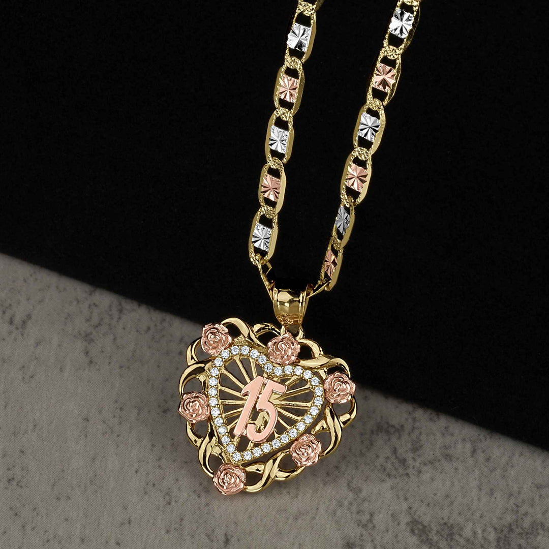 Two-tone yellow and rose gold heart-shaped pendant featuring a central "15" and floral accents.
