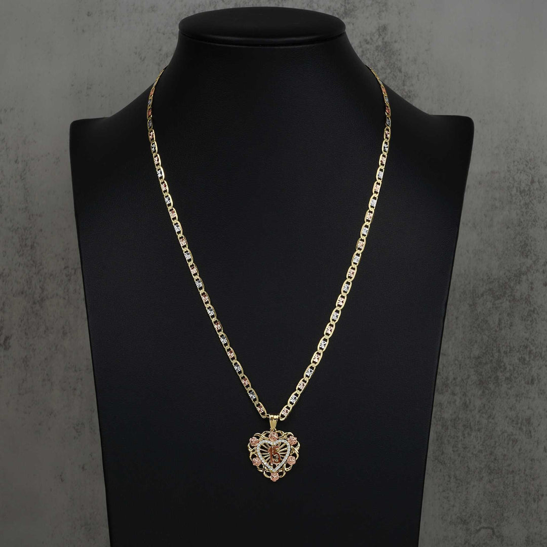 Two-tone Quinceanera heart pendant on a chain, displayed on a black jewelry bust.