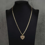 Two-tone Quinceanera heart pendant on a chain, displayed on a black jewelry bust.