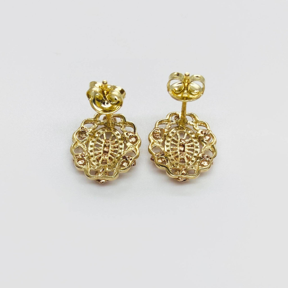 Back view of tri-color gold Quinceanera stud earrings showing posts and butterfly backs.