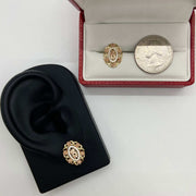 Tri-color gold Quinceanera stud earrings on a display stand with a quarter for scale.