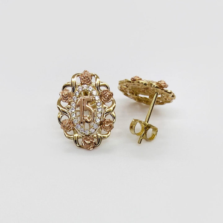 Tri-color gold Quinceanera stud earrings featuring a number 15 surrounded by rose accents.