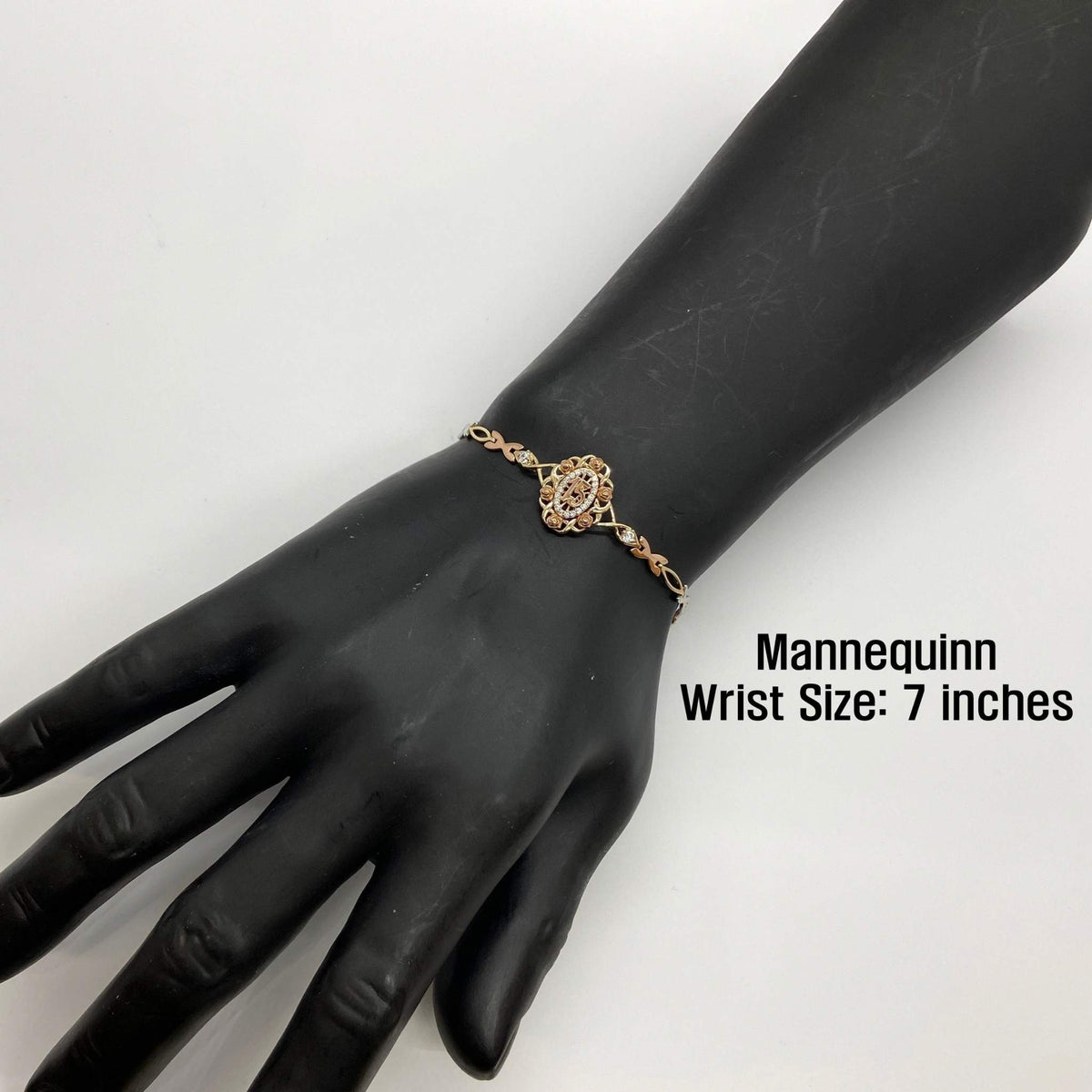 Tri-color gold Quinceañera 15 rose bloom bracelet displayed on a 7-inch mannequin wrist