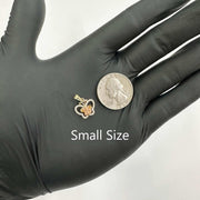 Small size two-tone gold Quinceañera butterfly pendant next to US quarter for scale.