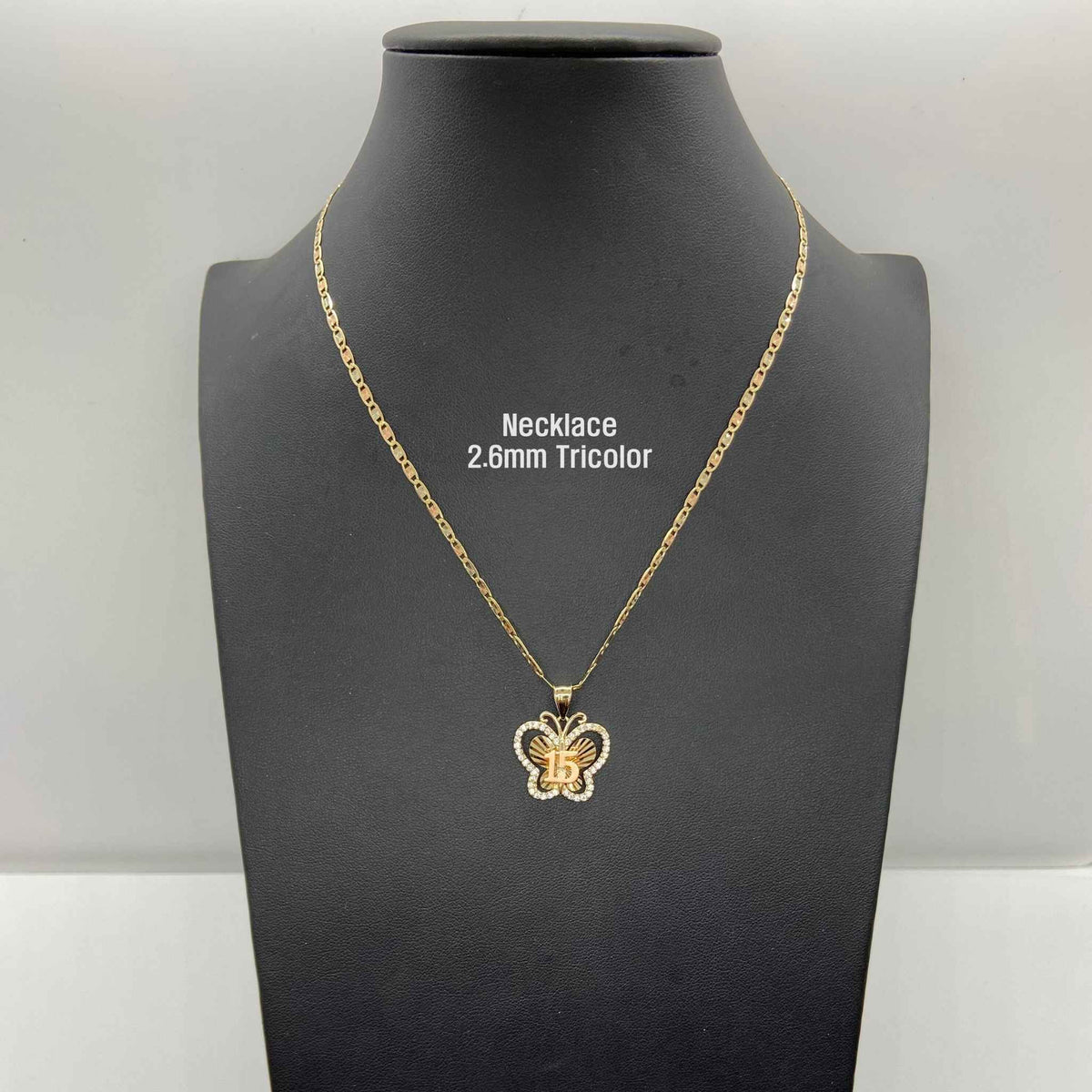 Two-tone gold Quinceañera butterfly pendant displayed on 2.6mm tricolor chain mannequin bust.
