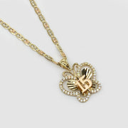 Close-up of CZ stones and gold 15 detail on butterfly pendant.