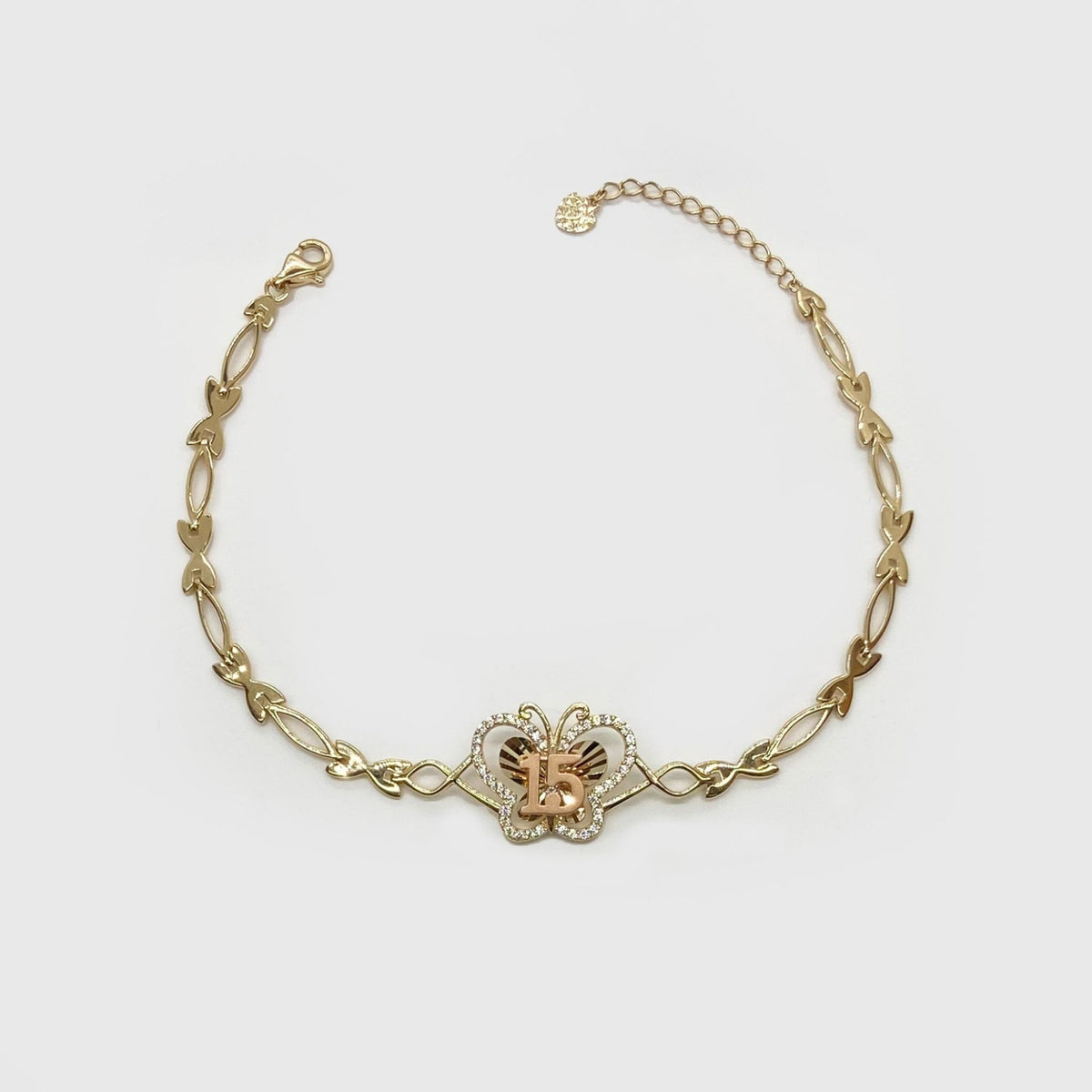 Gold Quinceañera 15 butterfly charm bracelet featuring CZ accents laid out in a loop