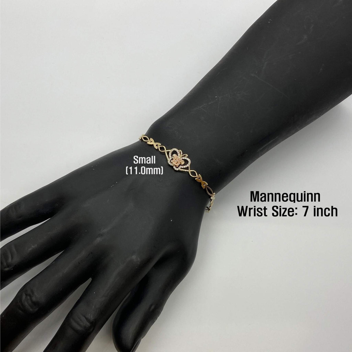 Small 11.0mm gold Quinceañera butterfly charm bracelet worn on a 7-inch mannequin wrist.