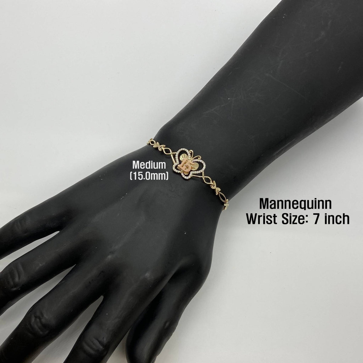 Medium 15.0mm gold Quinceañera butterfly charm bracelet worn on a 7-inch mannequin wrist