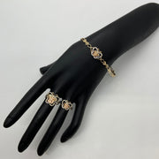 Gold Quinceañera 15 butterfly bracelet and matching ring set displayed on a black mannequin hand.