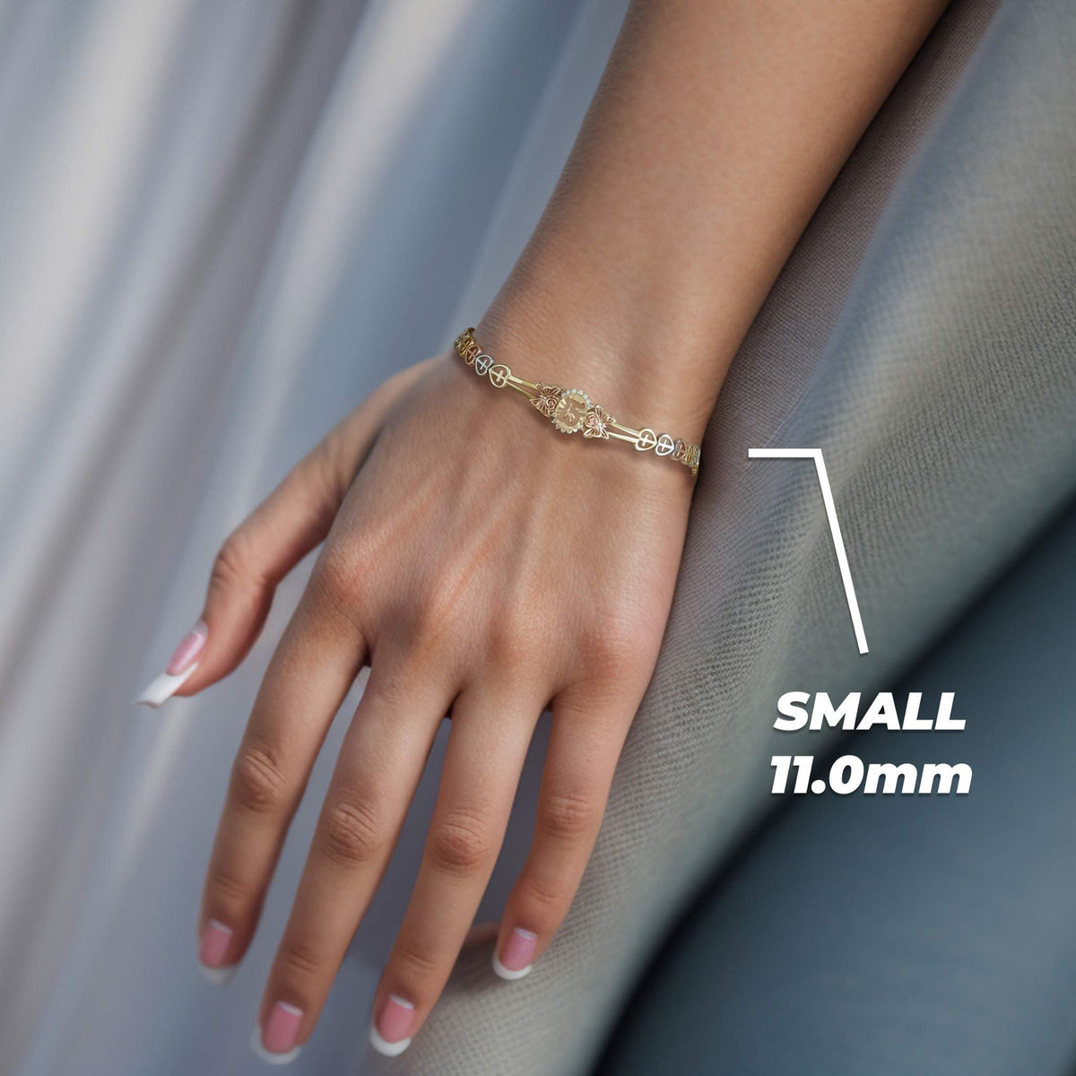 Model wearing a tri-color gold Quinceañera 15 bracelet with Small 11.0mm text overlay