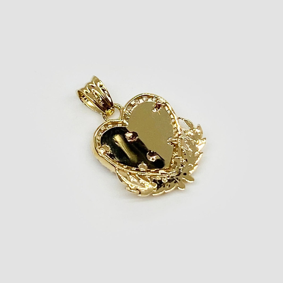 Back view of a gold Quinceanera heart wing pendant displaying textured mesh interior.