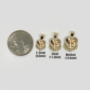 Three sizes of gold Quinceañera heart wing pendants shown next to a quarter for scale.