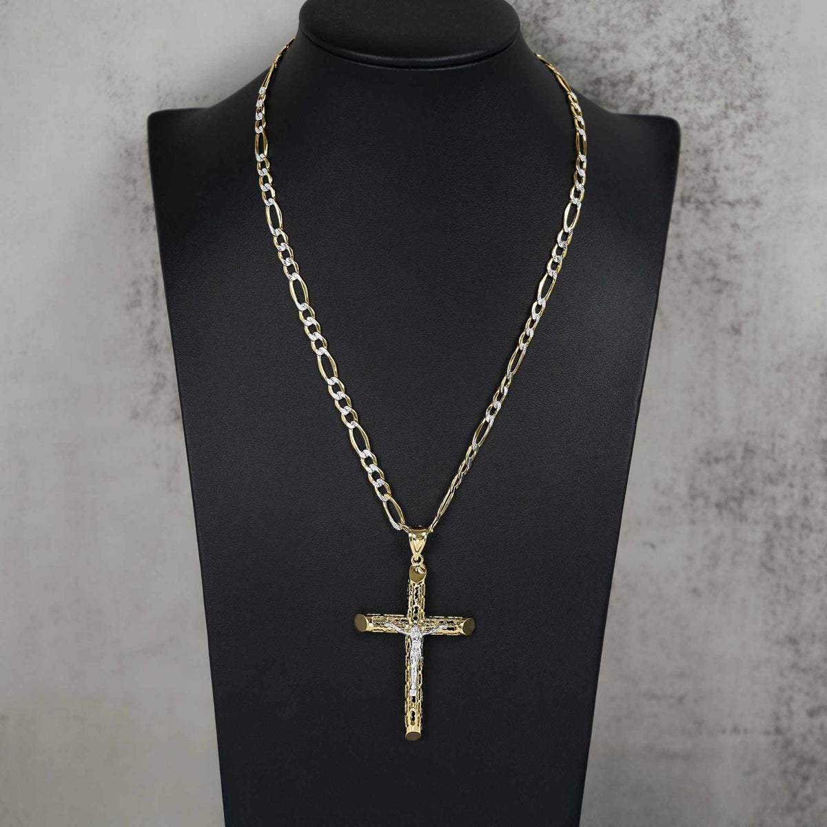 Two-tone gold crucifix cross pendant necklace displayed on a black jewelry mannequin bust.