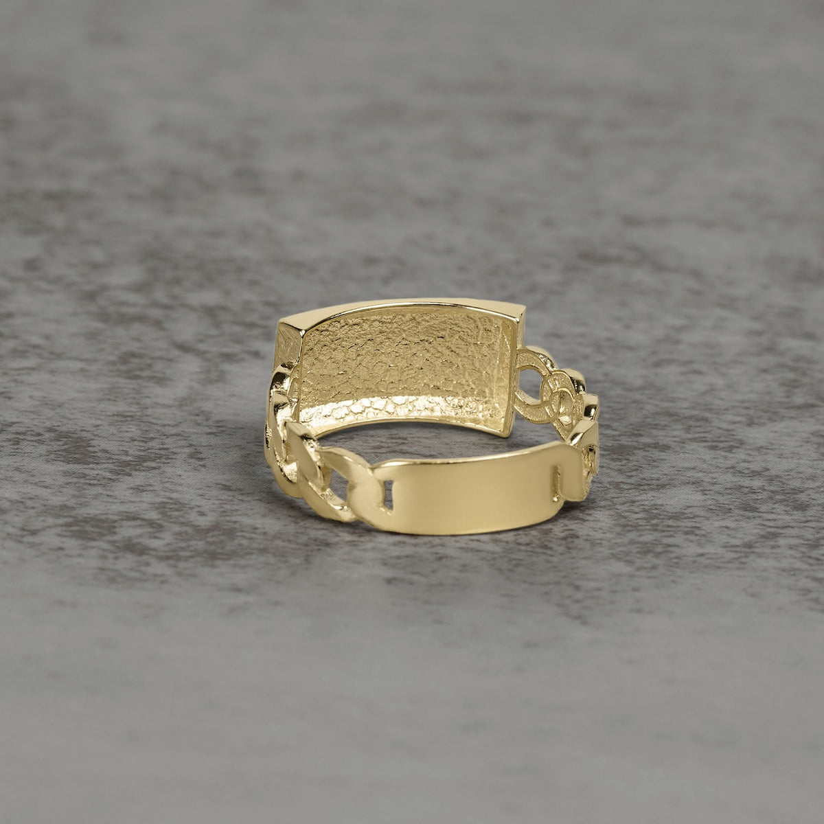 Solid gold Cuban link ID ring showcasing a hammered finish and smooth plate.