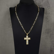 Yellow and white gold religious cross pendant on Figaro chain on black bust