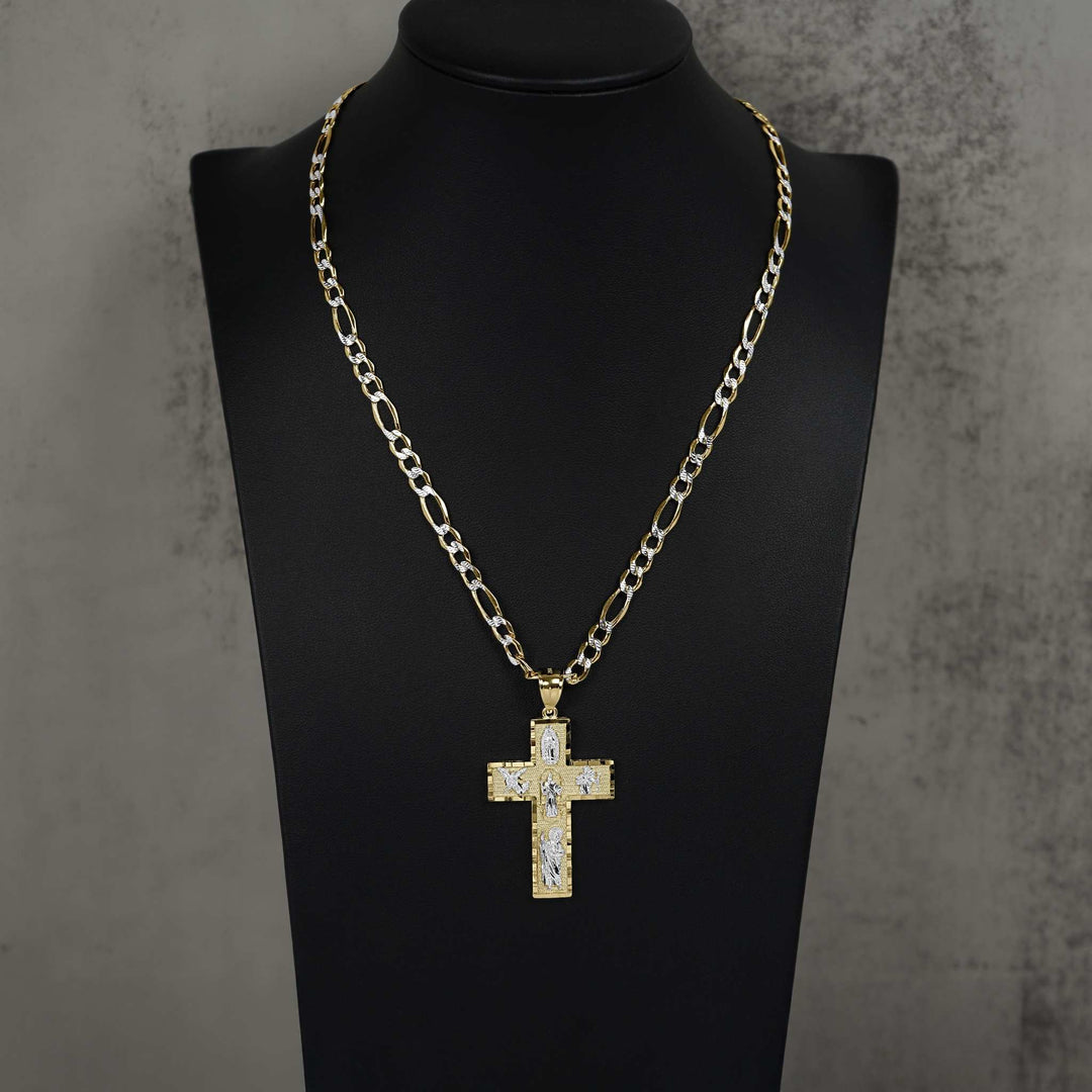 Gold cross pendant with pave stones on Figaro chain, displayed on black mannequin bust.