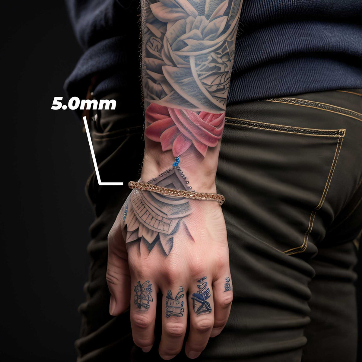 Model wearing a 5.0mm rose gold wheat palm chain bracelet on tattooed wrist.