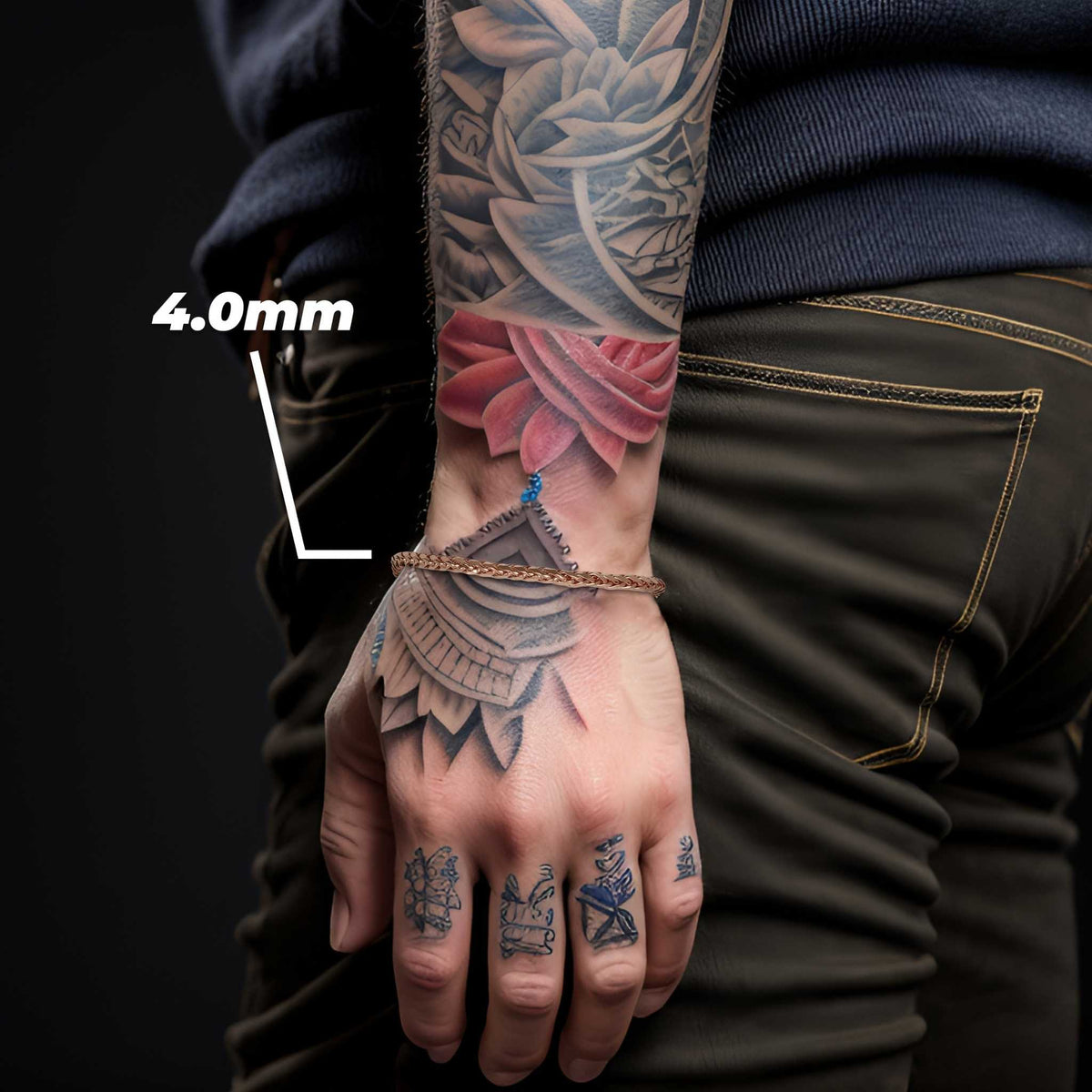 Model wearing a 4.0mm rose gold wheat palm chain bracelet on tattooed wrist.