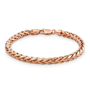 Rose gold classic wheat palm chain bracelet arranged in a full circle on white.