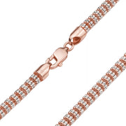 Close-up of rose gold lobster clasp on two-tone ice chain bracelet