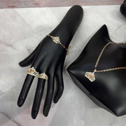 Gold Quinceañera crown jewelry set featuring a bracelet, two rings, and a necklace.