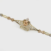Gold Quinceañera crown charm bracelet featuring a rose gold 15 and cubic zirconia.