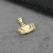 Back view of a gold Quinceañera royal crown pendant showing polished heart center.