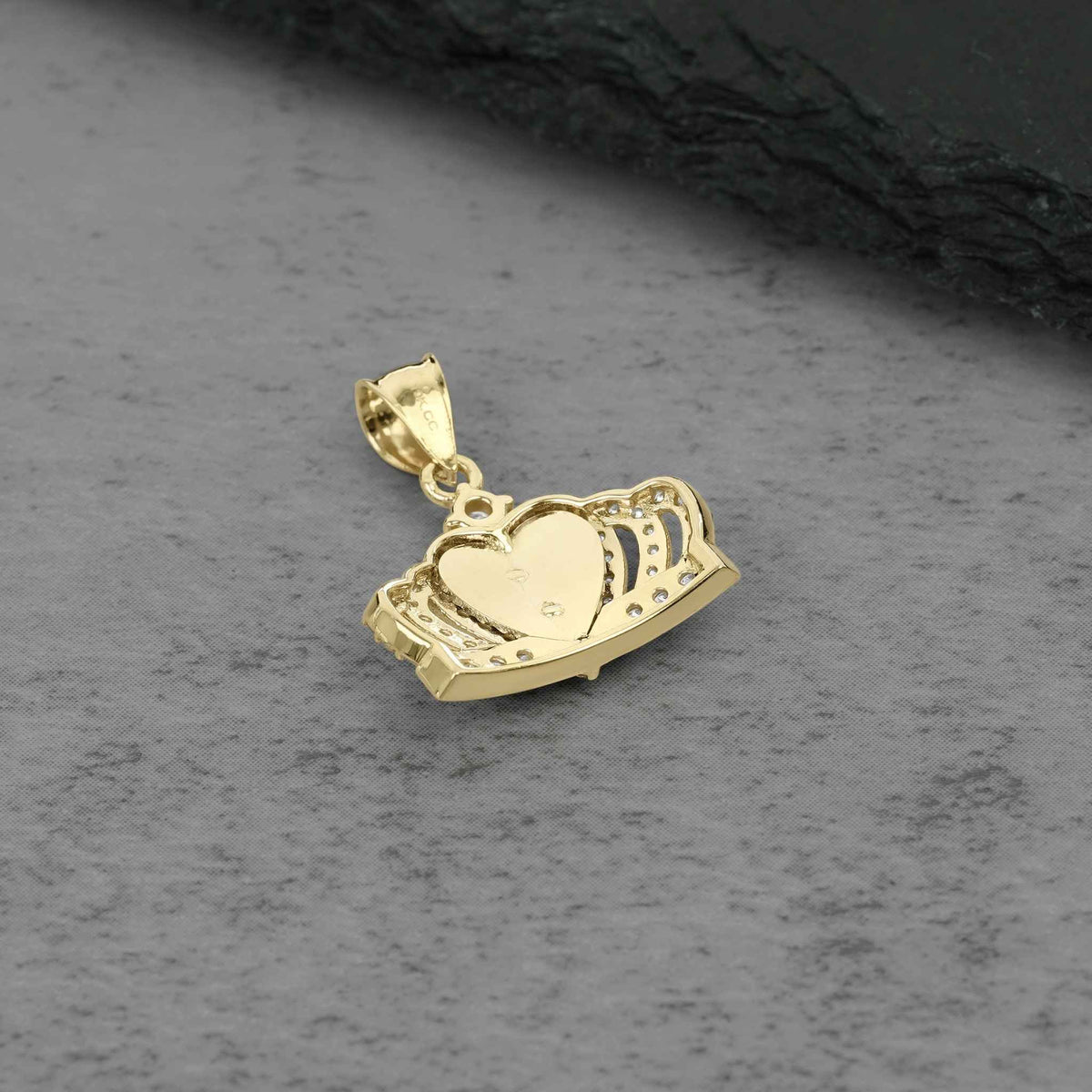 Back view of a gold Quinceañera royal crown pendant showing polished heart center.