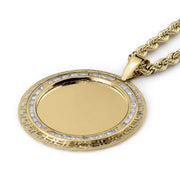 Gold pendant necklace with a round blank center, Greek key border, and rope chain.