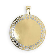 Round gold pendant with blank center and Greek key border set with clear stones.