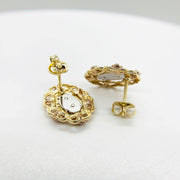 Reverse side of tri-color gold San Judas stud earrings with secure push-back closures.