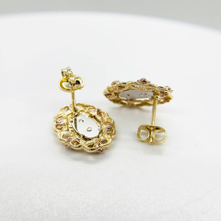 Reverse side of tri-color gold San Judas stud earrings with secure push-back closures.