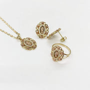 Tri-color gold San Judas jewelry set featuring pendant, earrings, and ring with rose accents.