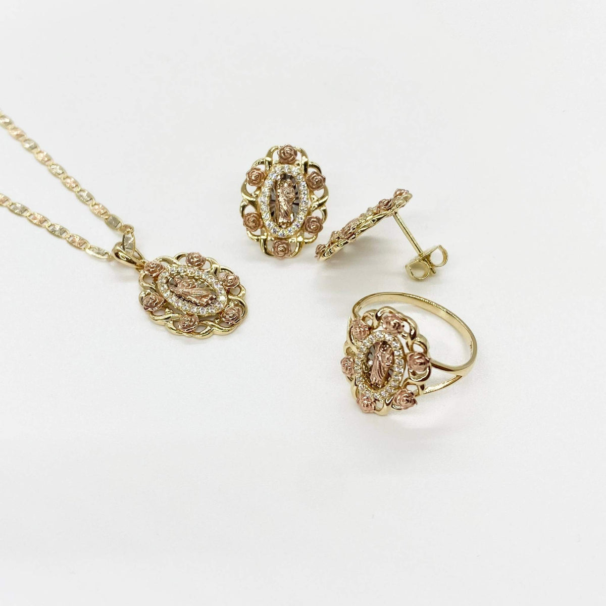 Tri-color gold San Judas jewelry set featuring pendant, earrings, and ring with rose accents.