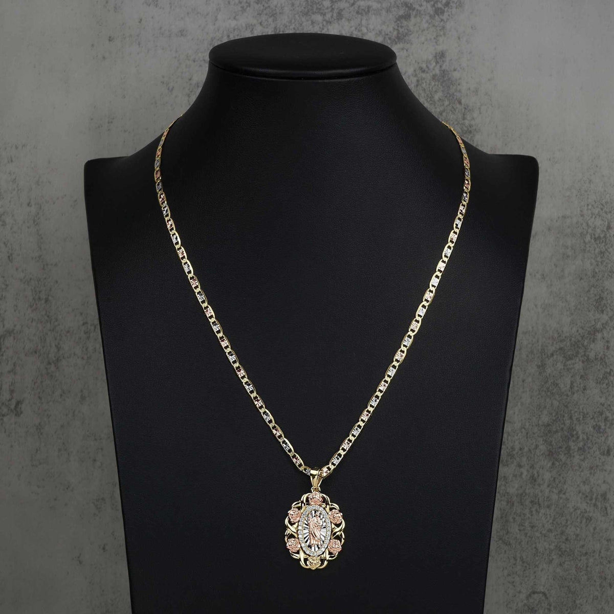 Tri-color gold San Judas oval pendant necklace displayed on a black mannequin bust.