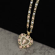 10k or 14k gold San Judas pendant necklace featuring rose gold floral details around a heart frame.