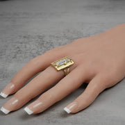 Model wearing a men's 10k two-tone gold rectangular San Judas signet ring on finger.