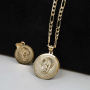 Gold Virgin Mary pendant necklace with a matching round medallion on display.