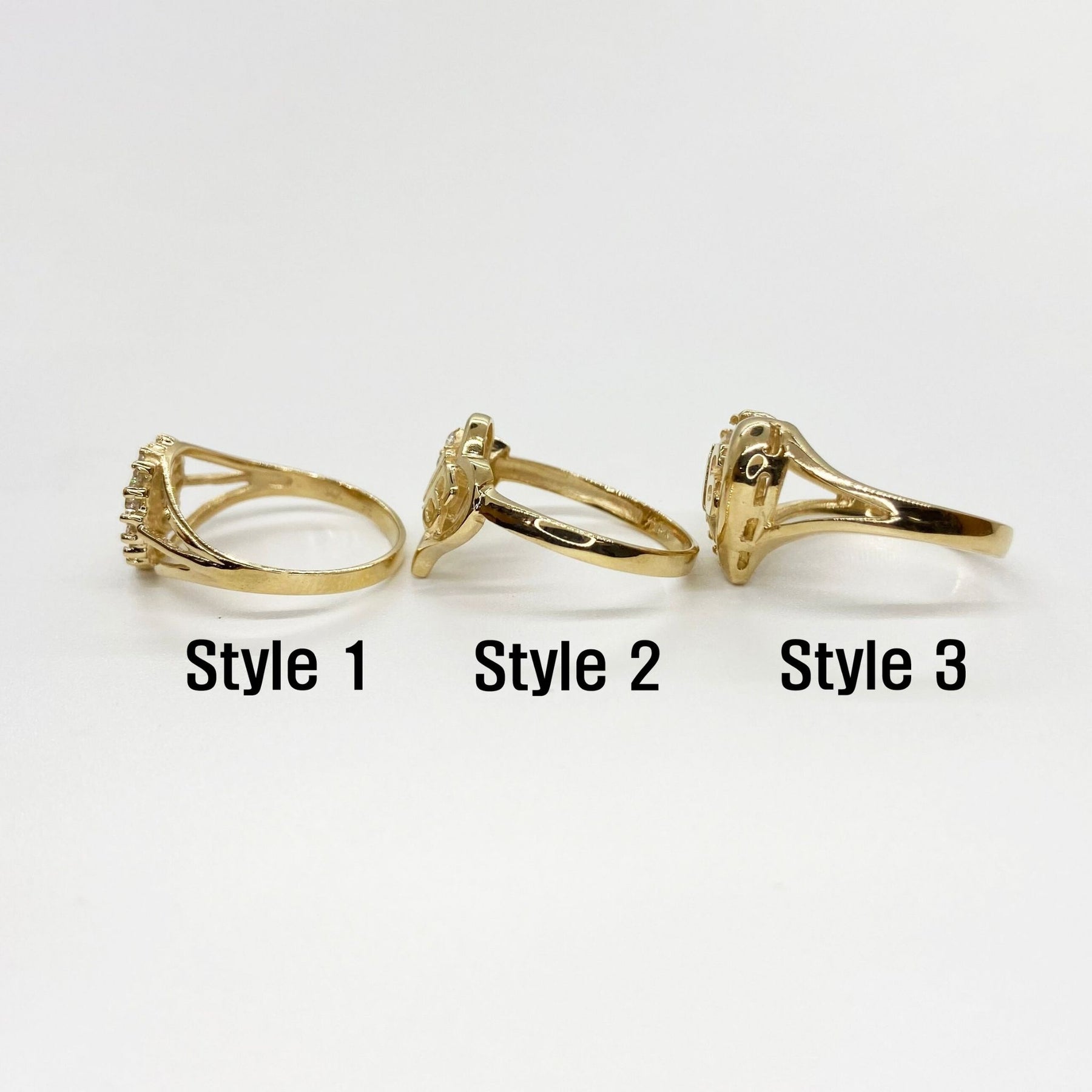 Three 10k - 14k gold Sweet 16 Heart rings side view with different styles.
