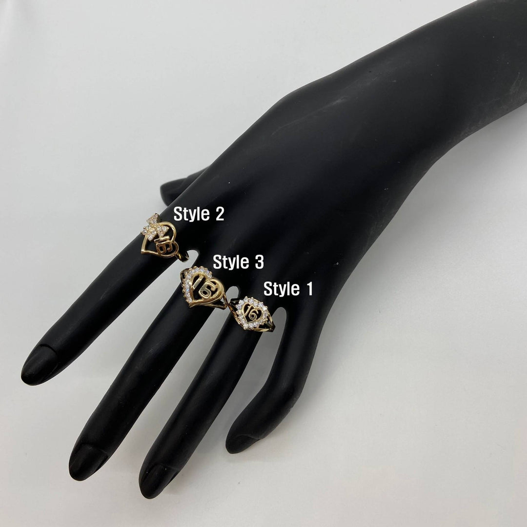 Black mannequin hand wearing three gold Sweet 16 Heart Ring with different designs.